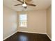 Bedroom with dark hardwood flooring, ceiling fan, and a window with blinds at 3820 Mast Nw Ct, Kennesaw, GA 30144