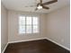 Bedroom with dark hardwood flooring, ceiling fan, and a window at 3820 Mast Nw Ct, Kennesaw, GA 30144