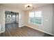 Bright dining area with wood-look floors next to a sunroom for added living space at 3820 Mast Nw Ct, Kennesaw, GA 30144