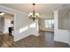 Open dining room featuring updated floors, a decorative chandelier, and stylish wainscoting at 3820 Mast Nw Ct, Kennesaw, GA 30144