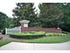 Landscaped entrance to Carillon Estates features brick signage and manicured hedges with white picket fence at 3820 Mast Nw Ct, Kennesaw, GA 30144