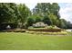 Madison community entrance showcasing lush landscaping, brick accents and mature trees at 3820 Mast Nw Ct, Kennesaw, GA 30144
