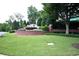 The entrance to Keswick features brick signage, landscaped flowers, and mature trees at 3820 Mast Nw Ct, Kennesaw, GA 30144