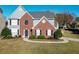 Charming two-story home with brick and siding, complemented by a well-manicured front yard and walkway at 3820 Mast Nw Ct, Kennesaw, GA 30144