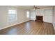 Bright living room features hardwood floors, built-in shelves, cabinets, and a brick fireplace at 3820 Mast Nw Ct, Kennesaw, GA 30144