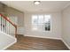 Bright living room featuring hardwood floors, white trim, and a staircase at 3820 Mast Nw Ct, Kennesaw, GA 30144