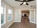 Inviting living space with wood-look flooring, ceiling fan, and French doors to an adjoining room at 3820 Mast Nw Ct, Kennesaw, GA 30144