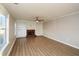 Spacious living room with hardwood floors, built-in shelves, cabinets, and brick fireplace at 3820 Mast Nw Ct, Kennesaw, GA 30144