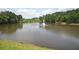 Picturesque pond featuring a fountain, surrounded by lush greenery and trees in Legacy Park at 3820 Mast Nw Ct, Kennesaw, GA 30144