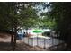 View of Legacy Park's community pool with splash pad, surrounded by trees at 3820 Mast Nw Ct, Kennesaw, GA 30144