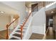 Elegant staircase with wooden handrail and white spindles, leading to the upper level at 3820 Mast Nw Ct, Kennesaw, GA 30144