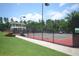 Outdoor tennis court at Legacy Park, fenced in and well-lit at 3820 Mast Nw Ct, Kennesaw, GA 30144
