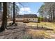 Extensive backyard with mature trees, deck, and landscaped areas, creating a private outdoor oasis at 4053 Thompson Mill Rd, Buford, GA 30519