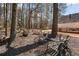 Serene backyard setting with outdoor seating, mature trees, and a glimpse of the home's exterior at 4053 Thompson Mill Rd, Buford, GA 30519