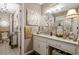 Elegant bathroom with a chandelier, decorative mirror, and granite countertops on the vanity at 4053 Thompson Mill Rd, Buford, GA 30519