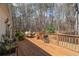 Inviting outdoor deck, perfect for relaxing, with seating and a grill, overlooking the wooded backyard at 4053 Thompson Mill Rd, Buford, GA 30519