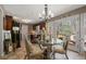 Charming dining area with glass table, stylish chairs, and french doors leading to an outdoor deck at 4053 Thompson Mill Rd, Buford, GA 30519