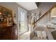 Entryway featuring tile flooring, a staircase, and decorative accents with natural light from front door at 4053 Thompson Mill Rd, Buford, GA 30519