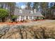 Charming home with a well-manicured lawn, black shutters, and a striking red door at 4053 Thompson Mill Rd, Buford, GA 30519