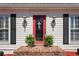 Close up of front door showing the sidelights, front door decor, and trimmed bushes at the front entrance at 4053 Thompson Mill Rd, Buford, GA 30519