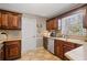 Well-lit kitchen featuring dark wood cabinetry, granite counters, and modern appliances at 4053 Thompson Mill Rd, Buford, GA 30519