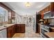 Spacious kitchen features dark wooden cabinets, stainless steel appliances, and an adjacent dining area at 4053 Thompson Mill Rd, Buford, GA 30519
