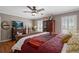 Comfortable main bedroom featuring a ceiling fan, hardwood floors, and natural light from the window at 4053 Thompson Mill Rd, Buford, GA 30519