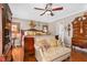 Comfortable bedroom with hardwood floors, a sitting area, and an ornate wooden bed frame at 4053 Thompson Mill Rd, Buford, GA 30519