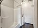 A well lit bathroom contains a shower and stackable washer and dryer at 878 Peachtree # 522, Atlanta, GA 30309