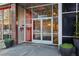 Building entrance with glass doors and nearby storefronts at 878 Peachtree # 522, Atlanta, GA 30309