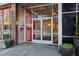 Modern building entrance featuring glass doors, a security system, and stylish planters at 878 Peachtree # 522, Atlanta, GA 30309