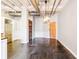 Open-concept living space featuring a modern light fixture, concrete floors, and access to the kitchen at 878 Peachtree # 522, Atlanta, GA 30309