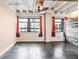 Inviting living room featuring exposed ceilings, polished floors, and large windows with cityscape views at 878 Peachtree # 522, Atlanta, GA 30309