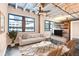 Bright living room featuring exposed ceiling, ceiling fan, large windows, and a wood accent wall at 878 Peachtree # 522, Atlanta, GA 30309