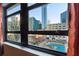 Stunning window view overlooking the city skyline and a well-maintained pool area at 878 Peachtree # 522, Atlanta, GA 30309