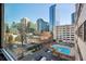 Window with city views overlooking a pool, parking, and landscaping at 878 Peachtree # 522, Atlanta, GA 30309
