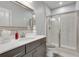 Bathroom features gray cabinets, light gray walls and a shower behind a glass door at 1007 Belle Ave, Roswell, GA 30076