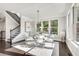 Bright dining area has large windows, modern decor and chandelier, conveniently located next to the staircase at 1007 Belle Ave, Roswell, GA 30076