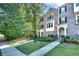 Charming brick townhome with manicured front lawn and black wrought iron fence at 1007 Belle Ave, Roswell, GA 30076