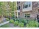 Charming brick townhouse with black iron fence and manicured landscaping at 1007 Belle Ave, Roswell, GA 30076