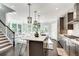 Bright open kitchen has bar seating, access to the breakfast area and staircase, with an abundance of natural light at 1007 Belle Ave, Roswell, GA 30076