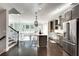 Modern kitchen with stainless steel appliances, island with bar seating, and hardwood floors at 1007 Belle Ave, Roswell, GA 30076