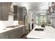 Stylish kitchen featuring stainless steel appliances, white subway tile backsplash, gray cabinets, and a kitchen island at 1007 Belle Ave, Roswell, GA 30076