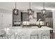 Modern kitchen with an island, stainless steel appliances, and stylish pendant lighting at 1007 Belle Ave, Roswell, GA 30076