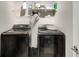 Laundry room with black washer and dryer at 1007 Belle Ave, Roswell, GA 30076