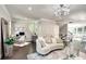 Bright living room featuring a modern chandelier, stylish sofa, and a convenient work-from-home desk setup at 1007 Belle Ave, Roswell, GA 30076