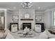 Elegant living room featuring a stone fireplace, stylish decor, and modern lighting at 1007 Belle Ave, Roswell, GA 30076