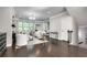 Spacious living room with fireplace, stylish seating, and a view towards the home office at 1007 Belle Ave, Roswell, GA 30076