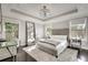 The main bedroom has a tray ceiling, dark hardwood floors, and two large windows at 1007 Belle Ave, Roswell, GA 30076