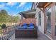Comfortable back porch with plush seating, brick accents, and a serene outdoor atmosphere at 3123 Neal Ct, Cumming, GA 30041